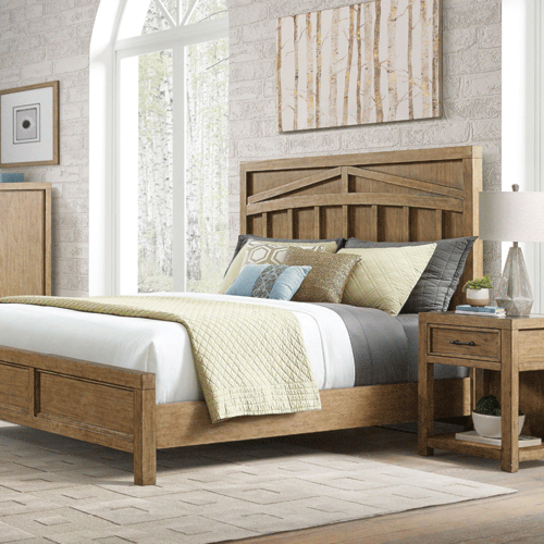 wooden bedframe with white sheets
